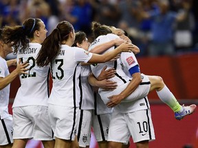 Kelley O'Hara of the United States celebrates with teammates as she scores the second goal in the FIFA Women's World Cup 2015 Semi-Final Match at Olympic Stadium on June 30, 2015 in Montreal, Canada.