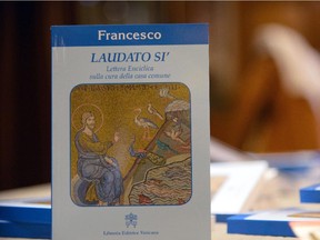A copy of Pope Francis's encyclical, a collection of principles to guide Catholic teaching, entitled "Laudato Sii " lies on a table during its official presentation, on June 18, 2015 at the Sinod hall at the Vatican. Pope Francis calls on the world's leaders to pull together to fight global warming, publishing his hotly-anticipated thesis on the environment which slams profiteers and slaves to progress. Released six months ahead of a key climate change meeting in Paris, Francis's text calls on international actors to take responsibility for "new modes of production, distribution and consumption."