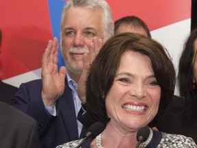 Quebec Liberal Party elected candidate Véronyque Tremblay, right, smiles as speaks to supporters after winning a by-election in Chauveau, as Quebec Premier Philippe Couillard, behind, applauds, Monday, June 8, 2015 in Loretteville, Que.