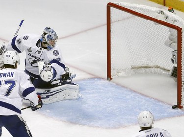 Tampa Bay Lightning goalie Andrei Vasilevskiy and teammate Victor Hedman (77) watch as a puck hits the post during the second period in Game 4 of the NHL hockey Stanley Cup Final against the Chicago Blackhawks Wednesday, June 10, 2015, in Chicago.