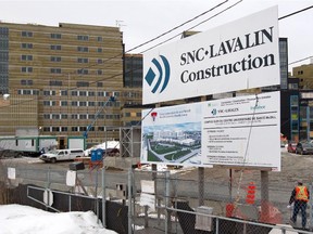 An SNC Lavalin sign displays the company's involvement in the MUHC construction project in Montreal Feb. 27, 2013.
