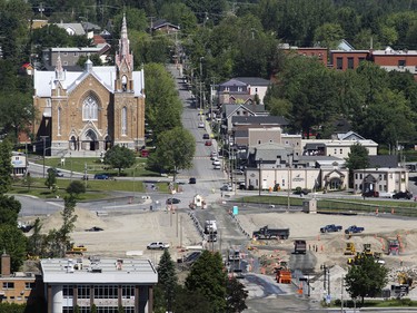 Trucks move about the disaster zone in the town of Lac-Mgantic, 250 kilometres east of Montreal Friday July 03, 2015.  Rebuilding of the town centre continues two years after the train derailment and fire that destoyed it and killed 47 residents.