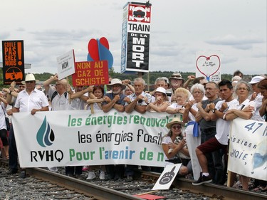 Protesters stop on the train tracks in Lac-Megantic, 250 kilometres east of Montreal Saturday July 04, 2015 to voice their opposition to the transport of oil by rail through their community.  The demonstration took place two days before the anniversary of the 2013 train derailment that levelled the centre of the town and killed 47 residents.