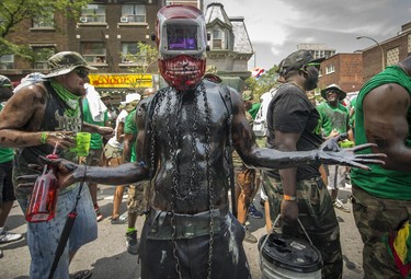 MONTREAL, QUE.: JULY 4, 2015 --  Covered in motor oil a Jab Jab Member dances down rue Ste. Catherine during the 40th Carifiesta parade in Montreal, on Saturday, July 4, 2015. (Peter McCabe / MONTREAL GAZETTE)