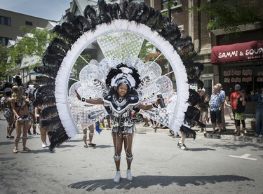 MONTREAL, QUE.: JULY 4, 2015 --  Wearing an elaborate costume a Member of Caribbean community dances down rue Ste. Catherine during the 40th Carifiesta parade in Montreal, on Saturday, July 4, 2015. (Peter McCabe / MONTREAL GAZETTE)