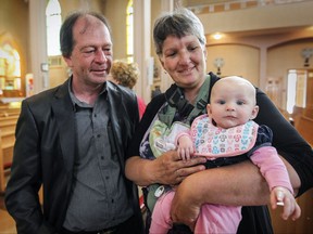 Clermont Pepin and Josee Lajeunesse with grand-daughter Oceanne after mass at Paroisse Ste-Agnes in Lac-Megantic, 250 kilometres east of Montreal Sunday July 05, 2015 one day before the 2nd anniversary of the train derailment and fire that destroyed the centre of the town, killing 47 people.  They lost their son Eric in the fire.