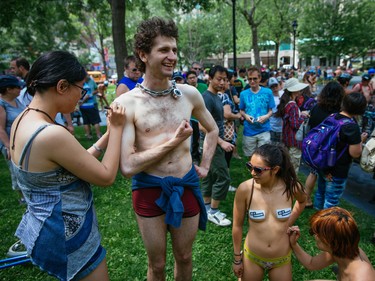 MONTREAL, QUE.: JULY 5, 2015 -- People gather to take part in the Montreal World Naked Bike Ride at Dorchester Square in downtown Montreal on Sunday, July 5, 2015. The World Naked Bike Ride event aims to encourage cycling, promote environmentalism, and address body image issues. (Dario Ayala / Montreal Gazette)