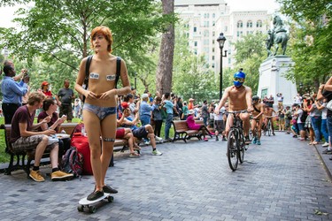 MONTREAL, QUE.: JULY 5, 2015 -- People take part in the Montreal World Naked Bike Ride at Dorchester Square in downtown Montreal on Sunday, July 5, 2015.  The World Naked Bike Ride event aims to encourage cycling, promote environmentalism, and address body image issues. (Dario Ayala / Montreal Gazette)