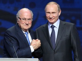 Outgoing FIFA president Sepp Blatter shakes hands with Russian President Vladimir Putin (R) ahead of the preliminary draw for the 2018 World Cup qualifiers at the Konstantin Palace in Saint Petersburg on July 25, 2015.  AFP PHOTO / KIRILL KUDRYAVTSEVKIRILL KUDRYAVTSEV/AFP/Getty Images