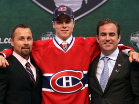 Head scout Trevor Timmins (left) and team owner/president Geoff Molson pose with defenceman Nathan Beaulieu after selecting him in the first round (17th overall) at the 2011 NHL Draft in St. Paul, Minn.