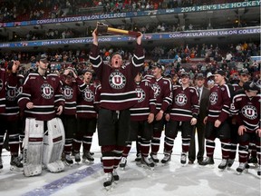 PHILADELPHIA, PA - APRIL 12:  Daniel Carr #9 of the Union College Dutchmen skates with the championship trophy after the win over the Minnesota Golden Gophers during the 2014 NCAA Division I Men's Hockey Championship Game at Wells Fargo Center on April 12, 2014 in Philadelphia, Pennsylvania.The Union College Dutchmen defeated the Minnesota Golden Gophers 7-4 to win the national title.