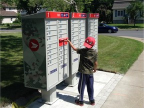 A child checks out new community mailbox installed by Canada Post at the corner Hornell and St-Louis Aves. in Pointe-Claire in early June.
