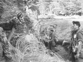 An enduring image of the summer of 1990: A Mohawk faces off against a Canadian soldier across razor wire.