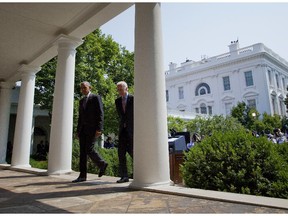 President Barack Obama and Vice President Joe Biden walk back to the Oval Office of the White House in Washington, Wednesday, July 1, 2015, after the president spoke in the Rose Garden. The president announced that US and Cuba have agreed to open embassies in each other's capitals, the biggest tangible step in the countries' historic bid to restore ties after more than a half-century of hostilities.