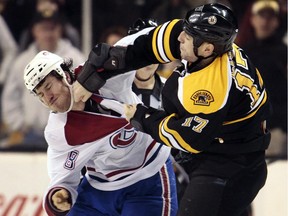 The Canadiens' Brandon Prust (left) exchanges blows with the Bruins' Milan Lucic during NHL game in Boston on March 3, 2013.