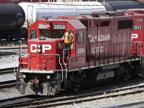 Canadian Pacific Railway locomotives move cars at a railyard in Calgary, in this undated file photo. Canadian Pacific and Canadian National are expected to temper their earnings outlook when they report results next week.