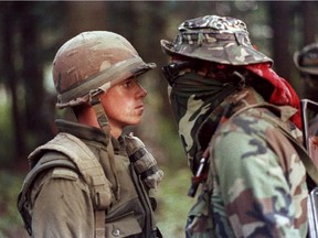 Canadian soldier Patrick Cloutier and Saskatchewan Native Brad Laroque alias "Freddy Kruger" come face to face in a tense standoff at Kanesatake  Saturday Sept. 1, 1990. It was a crisis that grabbed international headlines, with armed Mohawks and Canadian soldiers involved in a lengthy standoff that often appeared on the verge of exploding into full-blown combat.