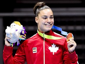 Caroline Veyre shows off her gold medal after defeating Dayana Sanchez of Argentina in the women's 57-60kg lightweight gold medal boxing final during the Pan American Games in Oshawa, Ont., on Saturday, July 25, 2015.