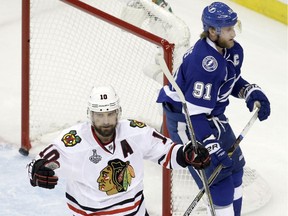 Chicago Blackhawks left wing Patrick Sharp (10) reacts as Tampa Bay Lightning centre Steven Stamkos (91) skates by after Sharp scored against the Tampa Bay Lightning during the first period of Game 5 of the NHL hockey Stanley Cup Final, Saturday, June 13, 2015, in Tampa, Fla.
