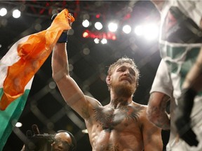 Conor McGregor celebrates after defeating Chad Mendes in their interim featherweight title mixed martial arts bout at UFC 189 Saturday, July 11, 2015, in Las Vegas.