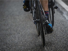 A cyclist rides in the rain during the 166 km second stage of the 102nd edition of the Tour de France cycling race on July 5, 2015, between Utrecht and Vrouwenpolder in Zeeland province, The Netherlands.
