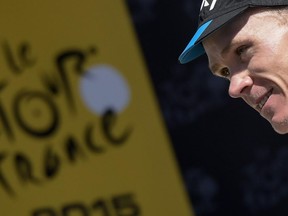 Great Britain's Christopher Froome celebrates his overall leader yellow jersey on the podium at the end of the 110,5 km 20th stage of the 102nd edition of the Tour de France cycling race on July 25, 2015, between Modane Valfrejus and Alpe d'Huez, French Alps.