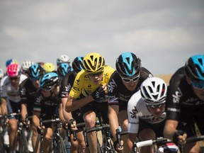 Great Britain's Christopher Froome (4thR) rides in the pack with his teammates of the Great Britain's Sky cycling team during the 181.5 km eighth stage of the 102nd edition of the Tour de France cycling race on July 11, 2015, between Rennes and Mur-de-Bretagne, western France.