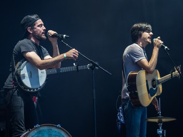 Scott Avett, left, and brother Seth Avett, right, of the Avett Brothers perform on day one of the 2015 edition of the Osheaga Music Festival at Jean-Drapeau park in Montreal on Friday, July 31, 2015.