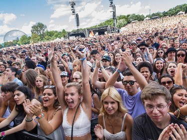 Music fans cheer during the performance by Angus & Julia Stone on day one of the 2015 edition of the Osheaga Music Festival at Jean-Drapeau park in Montreal on Friday, July 31, 2015.