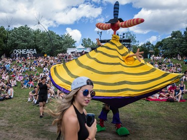 A large puppet walks among music fans on day one of the 2015 edition of the Osheaga Music Festival at Jean-Drapeau Park in Montreal on Friday, July 31, 2015.