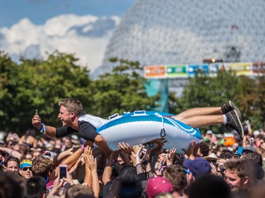 A music fan crowd surfs during the performance by Young the Giant on the second day of the 2015 edition of the Osheaga music festival at Jean-Drapeau park in Montreal on Saturday, August 1, 2015.