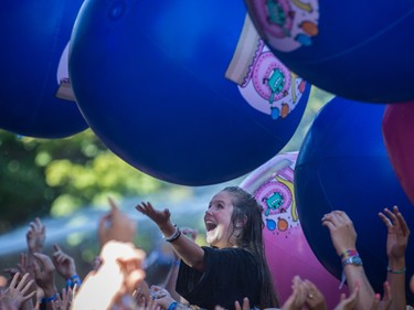 Giant beach balls bounce over music fans during the performance by Young the Giant on the second day of the 2015 edition of the Osheaga music festival at Jean-Drapeau park in Montreal on Saturday, August 1, 2015.