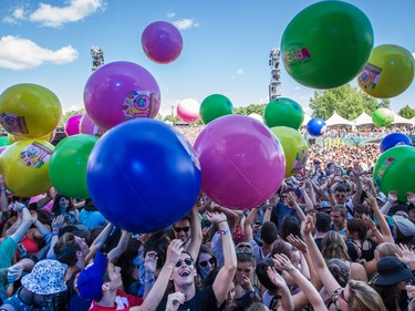 Giant beach balls bounce over music fans during the performance by Young the Giant on the second day of the 2015 edition of the Osheaga music festival at Jean-Drapeau park in Montreal on Saturday, August 1, 2015.