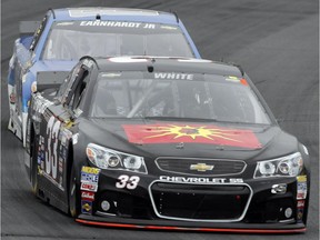 Derek White (33) leads Dale Earnhardt Jr. (88) during practice before Sunday's NASCAR Sprint Cup series auto race at New Hampshire Motor Speedway Saturday, July 18, 2015, in Loudon,NH