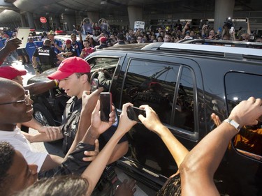 The car carrying Montreal Impact's newest player Didier Drogba is mobbed by fans as he leaves after arriving at Trudeau airport Wednesday, July 29, 2015 in Montreal.