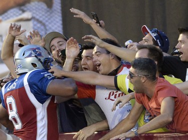 Montreal Alouettes slotback Nik Lewis (8) celebrates his touchdown against the Calgary Stampeders with fans during first half CFL football action in Montreal, Friday July 3, 2015. THE CANADIAN PRESS/Ryan Remiorz