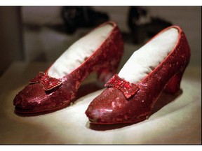 File photo shows one of the four pairs of ruby slippers worn by Judy Garland in the 1939 film "The Wizard of Oz" on display during a media tour of the "America's Smithsonian" traveling exhibition in Kansas City, Mo. An anonymous donor has offered a $1- million reward for credible information leading to a pair of the sequined shoes which was stolen from a museum in her Minnesota hometown, Grand Rapids. The 10-year anniversary of the theft is in August 2015.