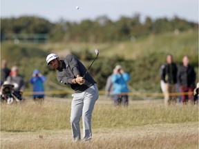US golfer Dustin Johnson plays from the rough during the completion of his second round 69, on day three of the 2015 British Open Golf Championship on The Old Course at St Andrews in Scotland, on July 18, 2015. American Dustin Johnson birdied the 18th hole to take the outright lead on ten under par at the Open Championship on Saturday after a marathon 10hr 28min delay due to high winds at St Andrews.
