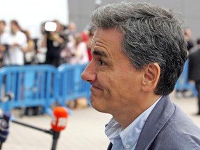 Greek Finance Minister Euclid Tsakalotos, arrives for a meeting of eurozone finance ministers in Brussels on Tuesday, July 7, 2015.