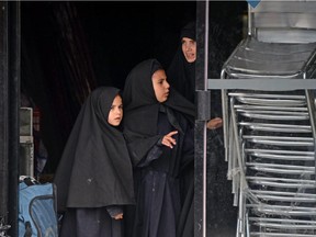 Women members of an ultra-Orthodox Lev Tahor Jewish group are seen at the entrance of the building where they will remain in Guatemala City on September 2, 2014.