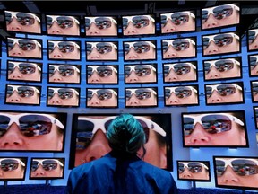 A woman looks at high-definition 3D television screens at Panasonic stand at the 2010 IFA technology and consumer electronics trade fair in Berlin.