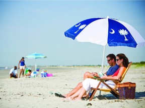 In this file photo provided the Charleston Area Convention & Visitors Bureau, people sit on a beach in Kiawah Island, S.C. Nearby Beachwalker Park on Kiawah Island is tenth on the 2013 list of Top 10 Beaches produced annually by coastal expert Stephen P. Leatherman, also known as "Dr. Beach," director of Florida International University's Laboratory for Coastal Research.