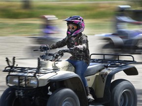 In this Saturday, July 11, 2015, photo, Taylee Barnes drives an ATV during a youth ATV safety course at the Weber County Fairgrounds in Ogden, Utah.