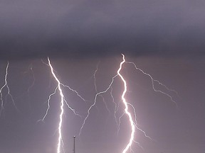 In this Wednesday, May 20, 2015 photo, lightning strikes between the towns of Krum and Sanger in Denton County, Texas, as a tornado warning was in effect for Sanger, Bolivar and Krum just after midnight. (Al Key/The Denton Record-Chronicle via AP)