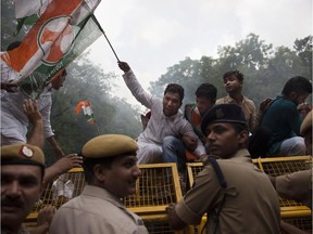 Indian police stop activists of India's opposition Congress party's youth wing protesting against Monday's rebel attack in Punjab state in New Delhi, India, Monday, July 27, 2015. Indian army commandos and police were in a gunfight Monday with militants who attacked a bus station and stormed into police barracks in a northern town bordering Pakistan.