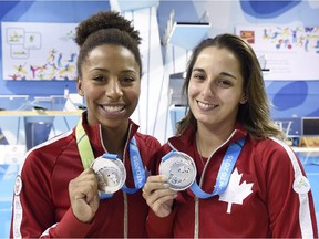 Jennifer Abel, left, and Pamela Ware show off their silver medals in the three-metre synchronized springboard diving final at the 2015 Pan Am Games in Toronto on Monday, July 13, 2015.