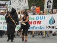 MONTREAL, QUE.: July 04, 2015 -- Protesters take to the streets of Lac-Megantic, 250 kilometres east of Montreal Saturday July 04, 2015 to voice their opposition to the transport of oil by rail through their community.  The demonstration took place two days before the anniversary of the 2013 train derailment that levelled the centre of the town and killed 47 residents. (John Mahoney / MONTREAL GAZETTE)