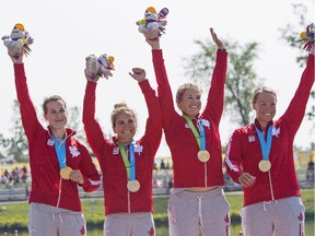 Canada's women's K4 kayak team, from left, Michelle Russell, Emilie Fournel, KC Fraser, and Hannah Vaughan, celebrate winning the first gold medal of the 2015 Pan Am Games in the 500m K4 in Welland, Ont.