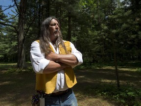 Kanesatake Grand Chief Serge Simon stands in the Pines near the scene of the police raid 25 years ago that started the Oka Crisis, June 18, 2015.