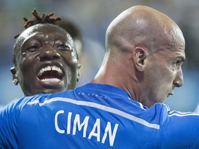 Montreal Impact's Laurent Ciman, right, celebrates with teammate Dominic Oduro after scoring against the Seattle Sounders during second half MLS soccer action in Montreal, Saturday, July 25, 2015.